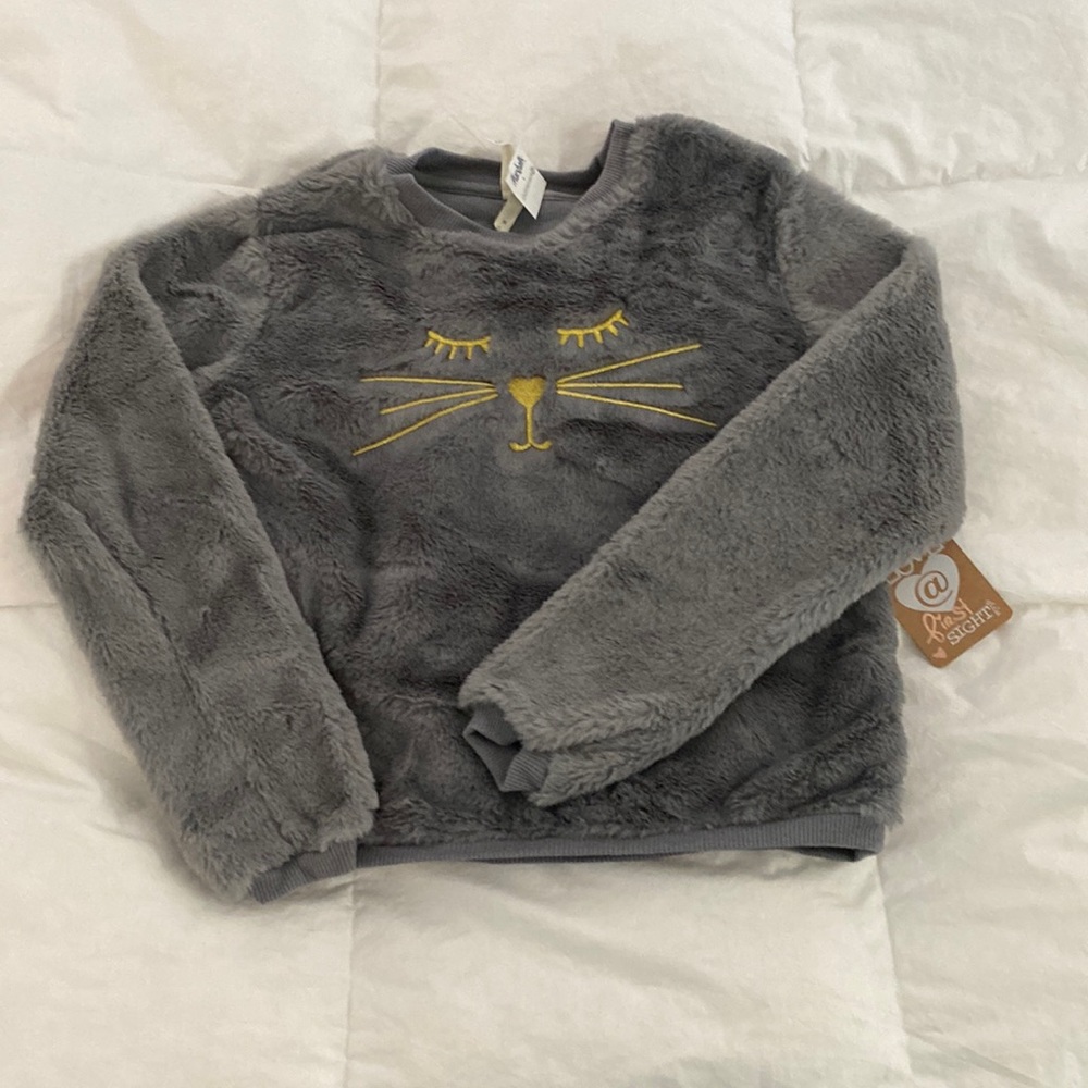 Gray, girls top . Very soft with cat stitching. Never worn . Great condition.